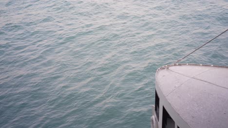 Looking-Down-At-Victoria-Harbour-Waters-With-Iconic-Star-Ferry-Sailing-Past