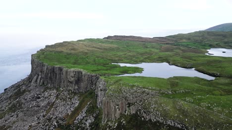 Aerial-wide-view-of-majestic-cliffs-of-Fair-Head-in-Northern-Ireland-overlooking-the-pristine-nature-and-unique-destination-for-an-travel-experience-for-hikers-and-climbers