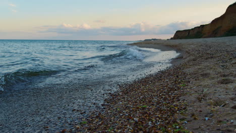 Sea-beach-at-sunset.-Ocean-water-waves-splashing-sand-coast.-Nature-background