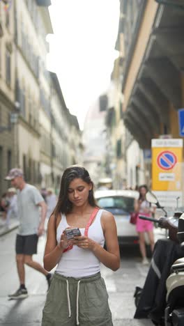 young woman using phone in florence