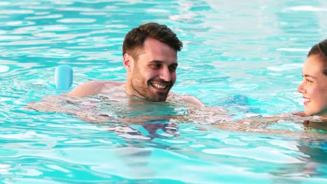 couple enjoying time together in swimming pool