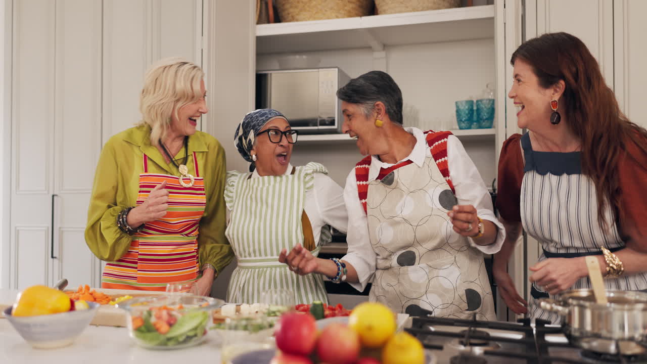 Group of women cooking and laughing in a kitchen