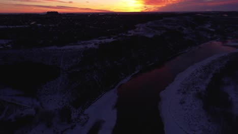 drone footage of calgary's winter wonderland during a beautiful sunrise with god rays