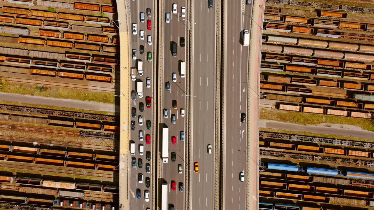 Aerial top down of city bridge with heavy traffic and abandoned train wagons