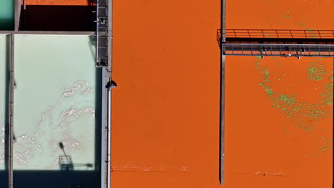 close-up of aeration tank in wastewater treatment facility with visible surface activity