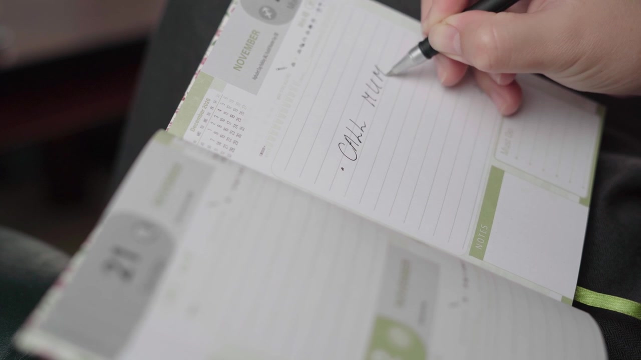 Woman notes a phone call with her mother in a November diary page, showing a quiet everyday planning moment.