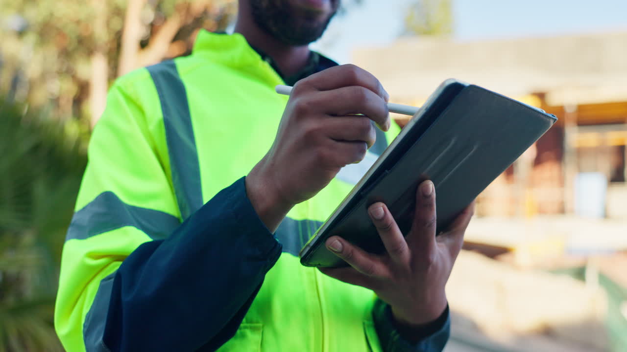 Construction worker using tablet on a building site