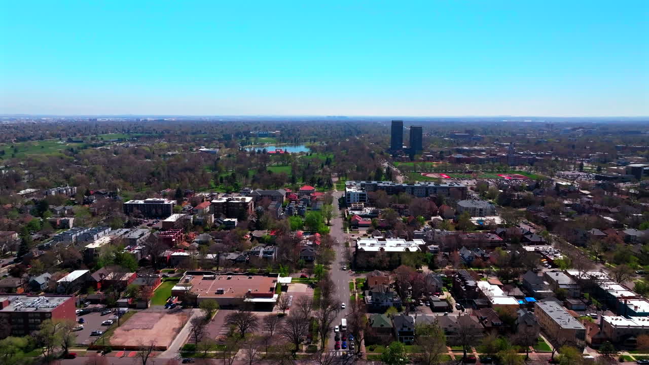 Denver cityscape Rocky Mountain Landscape spring summer City Park Washington Park aerial drone Colorado street tall buildings Front range Lodo Downtown cars sunny blue sky forward motion