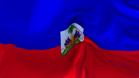 bandera de haiti ondeando en el viento animación en cámara lenta. 4k textura de tela realista bandera soplando suavemente en un día de viento fondo de bucle continuo sin costuras.