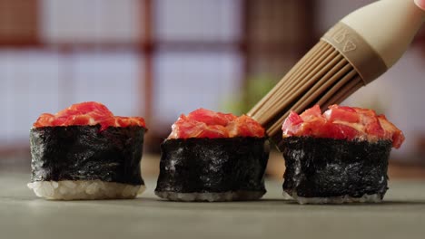 preparing sushi with a brush