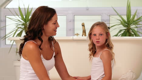 Little-girl-giving-her-mother-a-hug-and-kiss