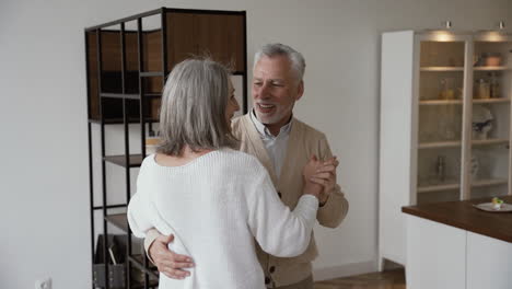 Feliz-Pareja-De-Ancianos-Bailando-Y-Abrazándose-En-Casa