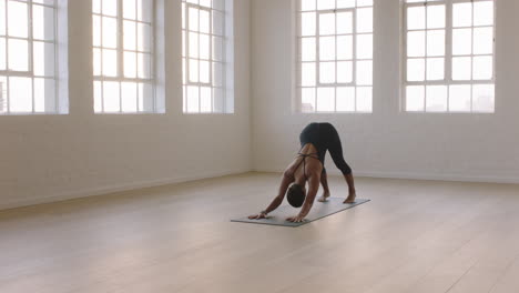 beautiful yoga woman practicing downward-facing dog pose enjoying fitness lifestyle exercising in studio stretching flexible body training early morning meditation on exercise mat