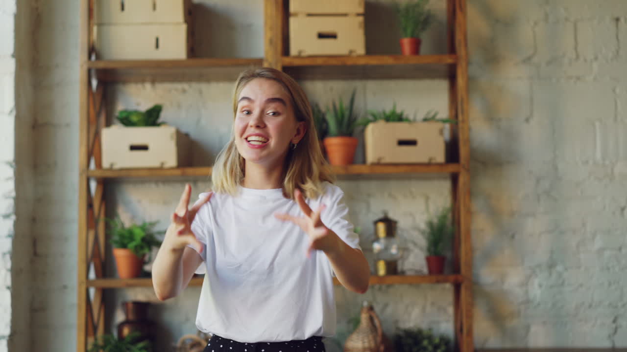 Young Woman Smiling at Camera in Home Office