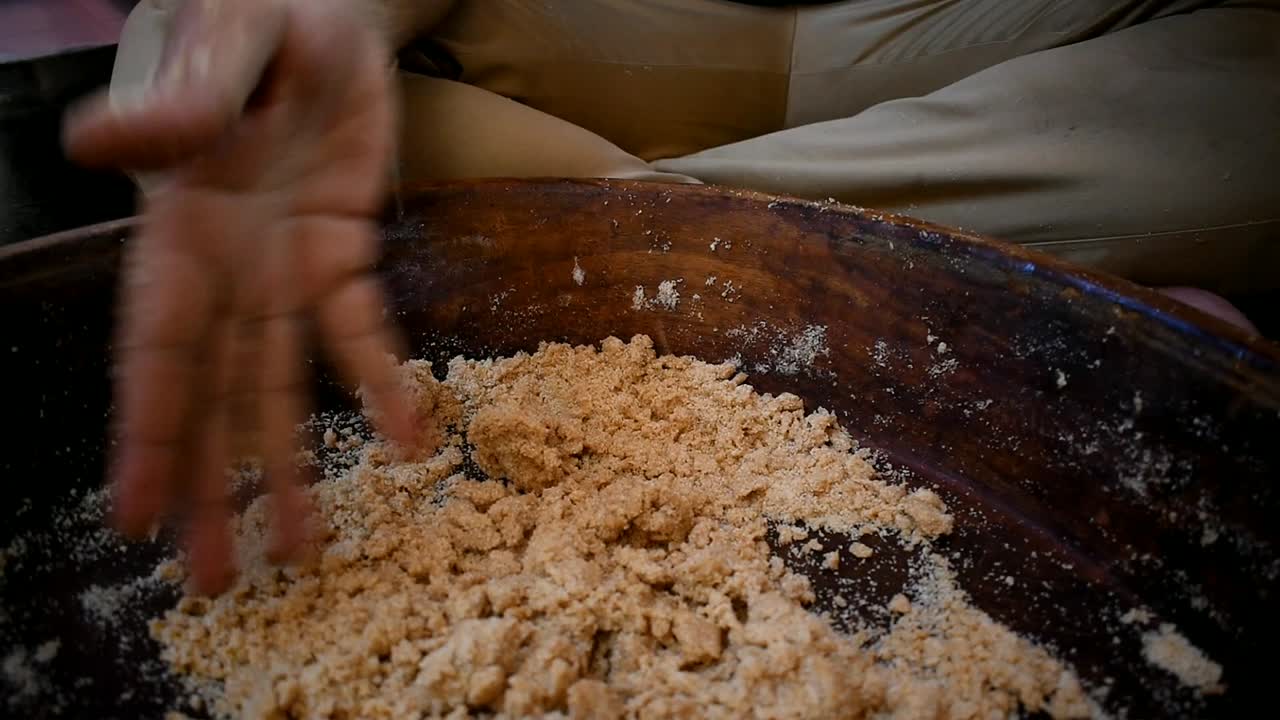 close up of pouring water for kneading dough