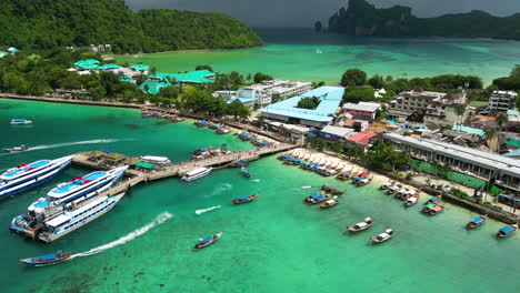 cruise and longtail boats at the ferry terminal of kho phi phi island, thailand, aerial view