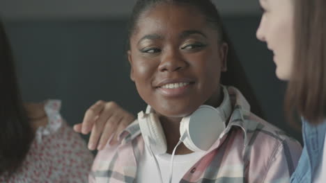 pretty black student girl talking with her friends,