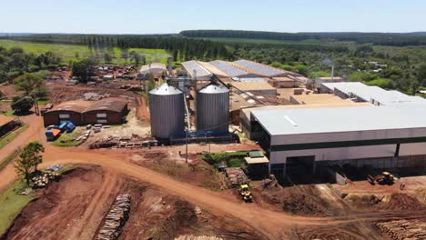 Drone-advancing-over-a-forest-industrial-plant-in-argentina