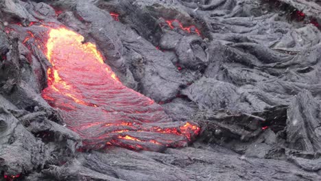 Lava-Flow-From-Eruption-Of-Fagradalsfjall-Volcano-During-Snowfall-At-Winter-In-Reykjanes-Peninsula,-South-Iceland