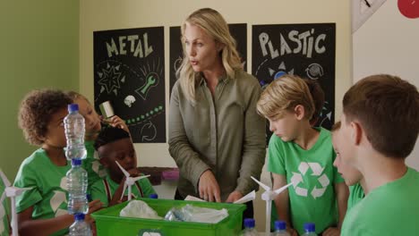 Female-teacher-teaching-about-recyclable-materials-in-the-class