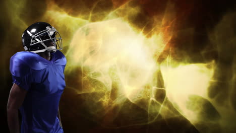 american football player holding helmet over light trails