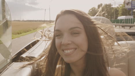 happy woman in a convertible car