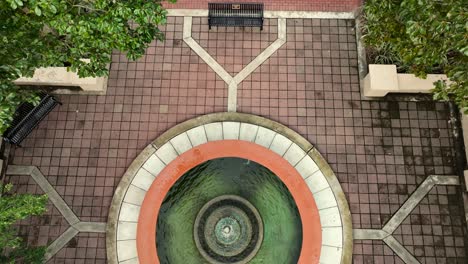 Aerial-reverse-reveal-of-a-watch-tower-and-park-in-Foley-Alabama-on-a-cloudy-day