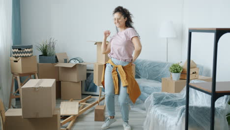 happy woman dancing in a new home