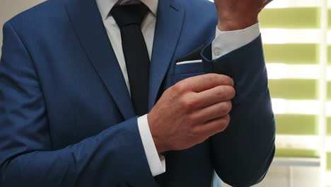 groom's preparing himself for wedding close up