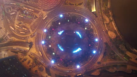 night time illuminated macau city traffic circle bay aerial topdown panorama 4k china