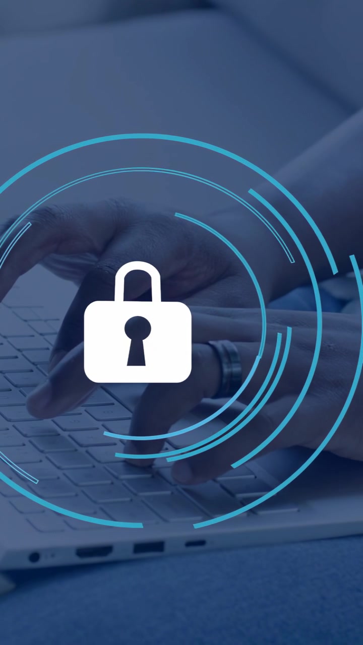 Vertical video: Man typing on laptop keyboard, lock icon and blue rings appearing, encrypting data