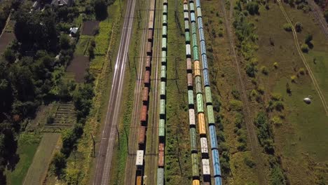 flying above industrial railroad station with cargo trains