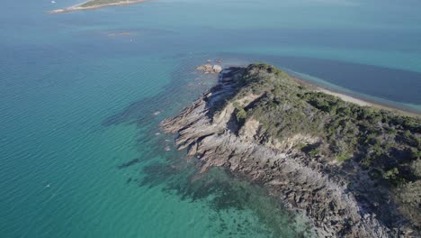 Aerial-Pullback-Over-Middle-Island-Surrounded-By-Clear-Blue-Sea