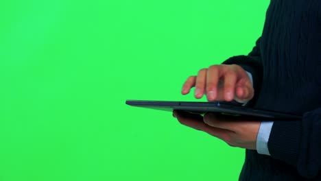 un hombre asiático trabaja en una tableta - estudio de pantalla verde - primer plano en las manos