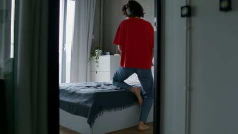 woman relaxing and working in her modern bedroom