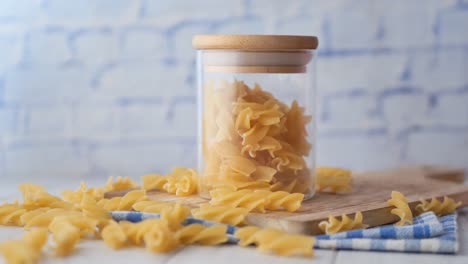 organic fusilli pasta in a jar on table