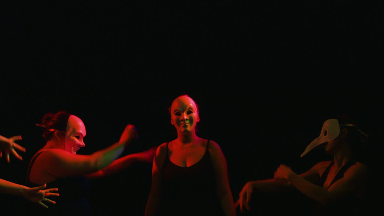 Women Dance in Masks in Colorful Lighting, Snap Zoom Closeup