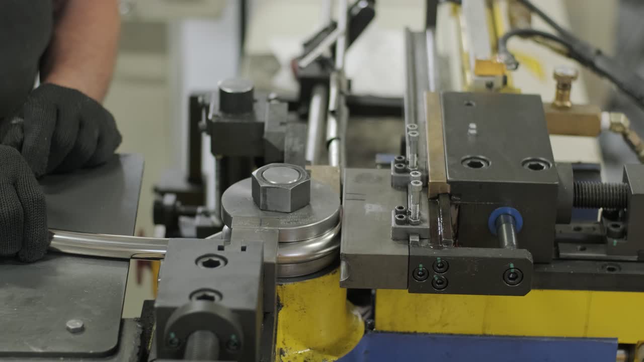 Industrial bender equipment machine for metal pipe bending in the factory. Automatic metalworking machine for electronic turning metal pipe and cold bending at industrial hall at manufacturing plant