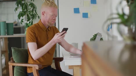 Albino-african-american-man-with-dreadlocks-making-video-call-on-the-laptop