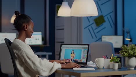 Dark skin freelancer retoucher woman working overtime on laptop