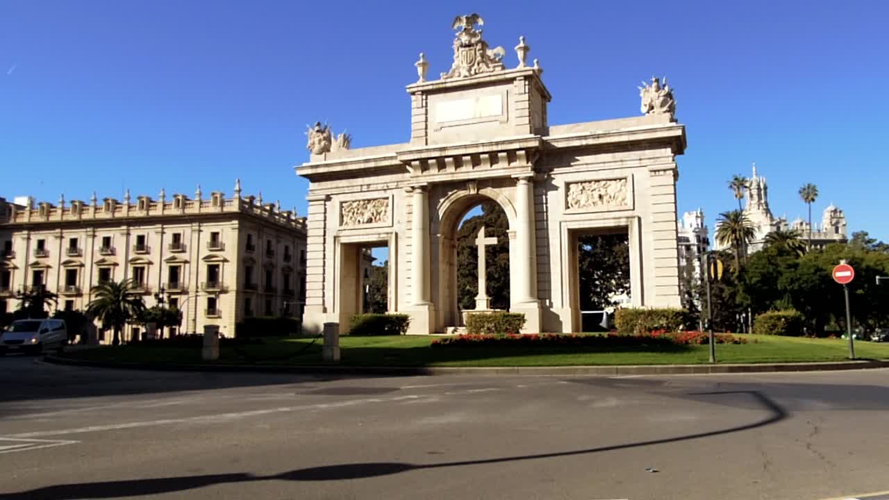 Pretty monument in valencia spain set in roundabout with cars and traffic going by time lapse
