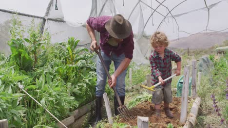 Happy-caucasian-father-and-son-gardening-in-greenhouse