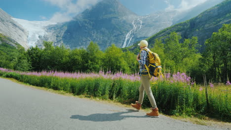 The-Incredibly-Beautiful-Nature-Of-Norway---A-Woman-With-A-Backpack-Walking-Along-A-Path-Against-The