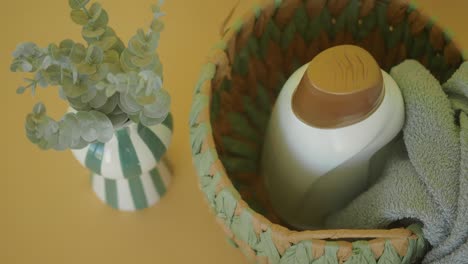 laundry basket with detergent and towel