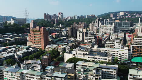 aerial pullback reveals sprawling city landscape of guandu beitou district, taipei, taiwan