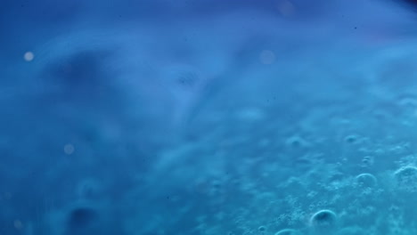 colorful liquids mixing and blending in a vibrant macro shot with bubbles and soft lighting