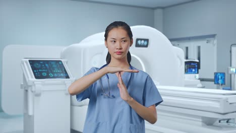Asian Female Doctor Doing Time Out Gesture With Hands With Mri Machine