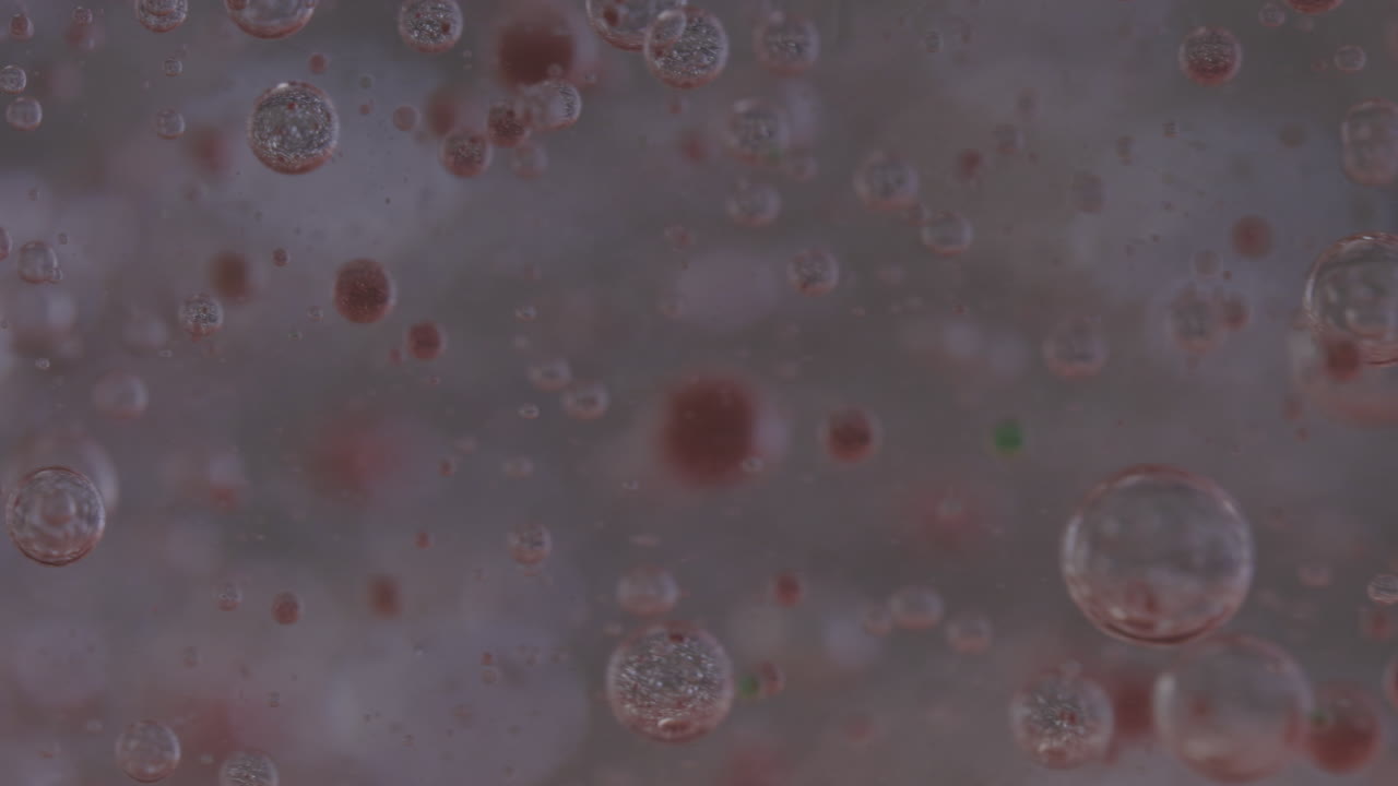 macro tiro de burbujas de diferentes colores que se mueven en el líquido transparente