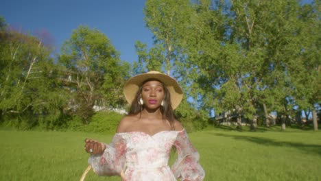 black woman looking eye contact in the park close up dolly in