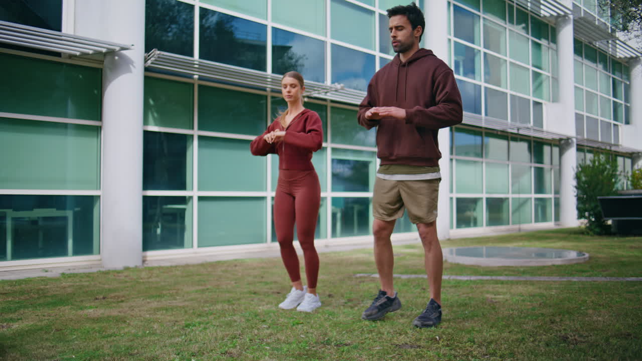 Athletes doing lunges outdoors together. Motivated sport people perform fitness